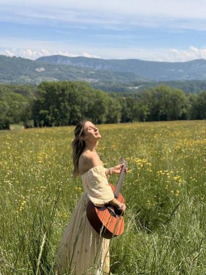 Playing guitar alone in a flower meadow