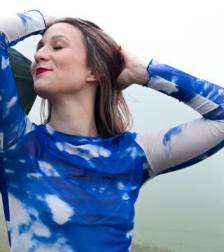 Writer two smiling, wearing a blue cloud-print top