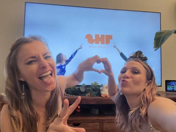 Watching their own music video, making heart hands